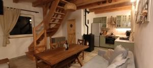 a living room with a wooden table and a kitchen at Smocze Ranczo 3 in Ośno Lubuskie