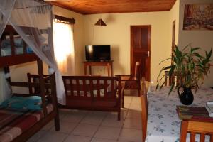 a room with a bunk bed and a living room at LA MARINA 4 in Ambodifototra