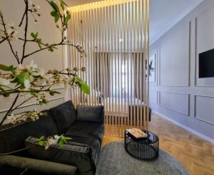 a living room with a couch and a chair at MINT Boutique Studio Apartments in Zagreb