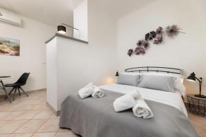 Posteľ alebo postele v izbe v ubytovaní Apartments Lacrima