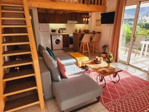 a living room with a couch and a stair case at Luxury Loft Apartment Vivian in Patra