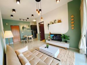a living room with a couch and a fireplace at Seafront Country Garden Danga Bay by Lions Bay in Johor Bahru