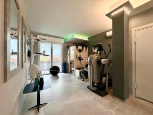a room with a gym with a treadmill in it at OliVia Rooms Sauna & Gym in Forlì