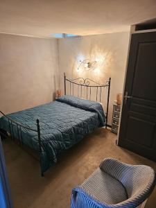 ein Schlafzimmer mit einem Bett und einem Stuhl darin in der Unterkunft Maison Allauch La Gloire de mon Père in Allauch