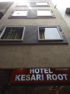 a hotel kermit root sign on the side of a building at Kesari root in Amritsar