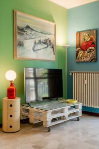 a living room with a flat screen tv on a table at La Casa dell’Artista - Appartamento in Milan