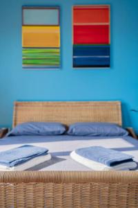 1 dormitorio con 2 camas y pinturas coloridas en la pared en La Casa dell’Artista - Appartamento, en Milán