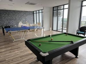 a billiard room with a pool table and two tables at The Podium 3 bedrooms @ 8 pax Free Internet & TV Box in Kuching