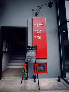 a sign in front of a building with a staircase at M2 Living @ Heart of Ipoh in Ipoh