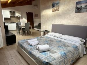 a bedroom with a large bed with towels on it at B&B Le Mansarde in Pescara