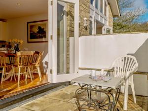 a patio with a table and chairs on a porch at 4 bed in Lulworth CHRIC in West Lulworth