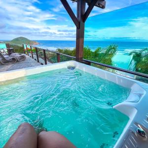 a hot tub with a view of the ocean at Pousada Descanso do Rei - Vista Para o Mar & Melhor Localização da Praia do Rosa in Praia do Rosa