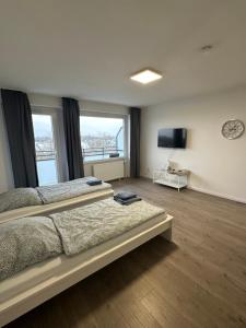 a bedroom with two beds and a flat screen tv at Stay-Happy Flat in Halstenbek in Halstenbek