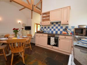 a kitchen with a table and a stove top oven at 2 Bed in Sherborne FOLKI in Long Burton