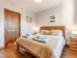 a bedroom with a bed with two towels on it at 1 Bed in Sennen CLOPC in St Just