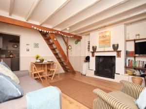 a living room with a couch and a fireplace at 1 Bed in Appledore MASTR in Appledore