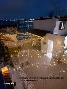 a string of lights on a rooftop at night at coraline in Castellammare di Stabia