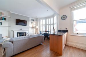 a living room with a couch and a table at The Richmond Apartments in Richmond upon Thames