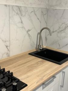 a kitchen with a sink and a counter top at The Cube in Kremenchuk