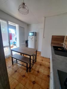 een keuken met een houten tafel en een houten vloer bij T1 tout confort in Saint-Denis