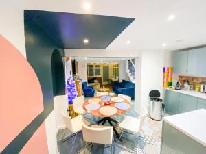 a kitchen and dining room with a table and chairs at Big House with En-suites a Big garden and Hot-tub near TOWER BRIDGE in London