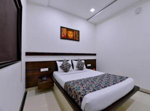 a bedroom with a bed and a picture on the wall at HOTEL SUNIL INN in Raipur