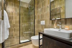 y baño con aseo, lavabo y ducha. en Neighbourgood 84 Harrington en Ciudad del Cabo