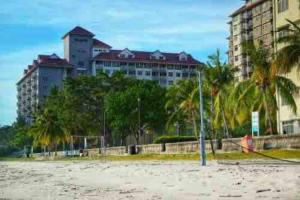 a volleyball court on the beach in front of buildings at 12pax Seaside Homestay Port Dickson 3R3B,Wifi,Beach,Pool,BBQ in Port Dickson