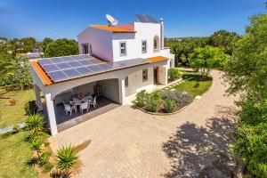 an aerial view of a house with solar panels on the roof at Villa Figueiras by Villa Plus in Lagoa