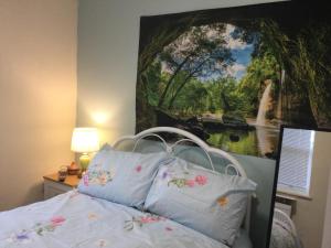 1 dormitorio con 1 cama con una pintura en la pared en TDM Bachelot Lettings Ltd en Londres