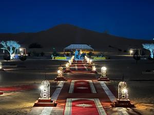 a group of lights in a parking lot at night at Desert Sahara Luxury Camp in Merzouga