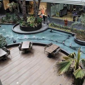 a mall with tables and chairs and a fountain at Luxury apartment in Istanbul