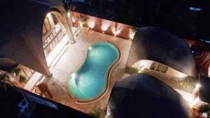 an overhead view of a swimming pool at night at Bamboo Estate Legian in Legian