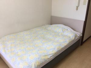 Voodi või voodid majutusasutuse Business Inn Grandeur Fuchu toas