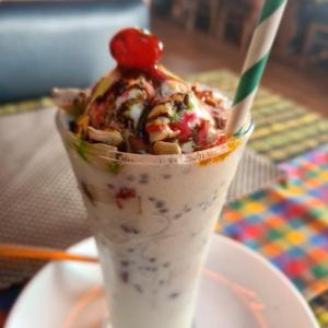a cup of ice cream with a cherry on top at Mannat Inn TS Mysore - Premium Homestay in Mysore