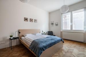 Posteľ alebo postele v izbe v ubytovaní Liget Apartment