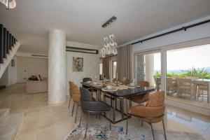 een eetkamer met een eettafel en stoelen bij BEACH FRONT SUPER VİLLA Boss 1 in Bodrum City