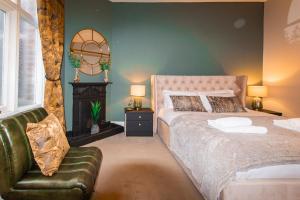 a bedroom with a bed and a couch and a chair at WhiteGates Rows City Centre Apartment by Rework Accommodation in Chester