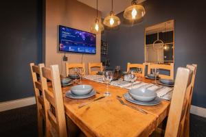 a dining room with a wooden table and chairs at WhiteGates Rows City Centre Apartment by Rework Accommodation in Chester