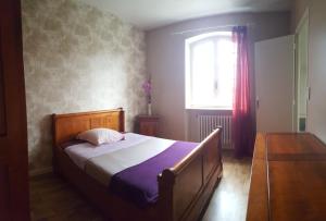 Schlafzimmer mit einem Bett und einem Fenster in der Unterkunft le relais fleuri in Alès