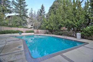 a large swimming pool in a yard with trees at Menlo Park 3br w pool patio nr great schools SFO-1532 in Menlo Park
