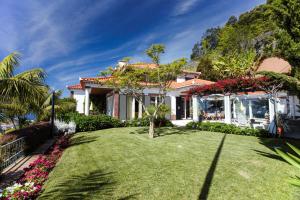 a house with a lawn in front of it at Villa Rostrum by Villa Plus in Funchal