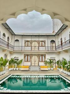 an indoor pool in the lobby of a hotel with a building at Dev Niwas - Heritage Hotel in Būndi