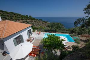a villa with a swimming pool and a house at Avgi Villa in Glossa