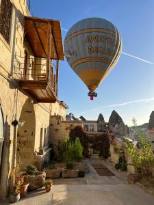 a hot air balloon flying over a building at Naraca Cave House in Goreme