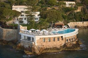 an aerial view of a house in the water at Hotel Cap Estel in &Eacute;ze