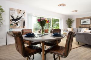 a living room with a table with chairs and a couch at The Sheep Fold in Melrose