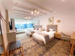 a hotel room with two beds and a television at Fresh Hours Hotel - West Lake Qingchun in Hangzhou