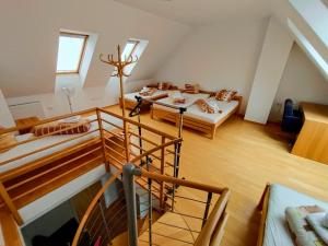 an attic room with two beds and a staircase at Bovec Garni Apartment 7 in Bovec