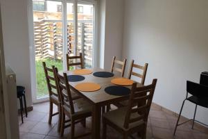 mesa de comedor y sillas con mesa y ventana en Bovec Garni Apartment 7 en Bovec